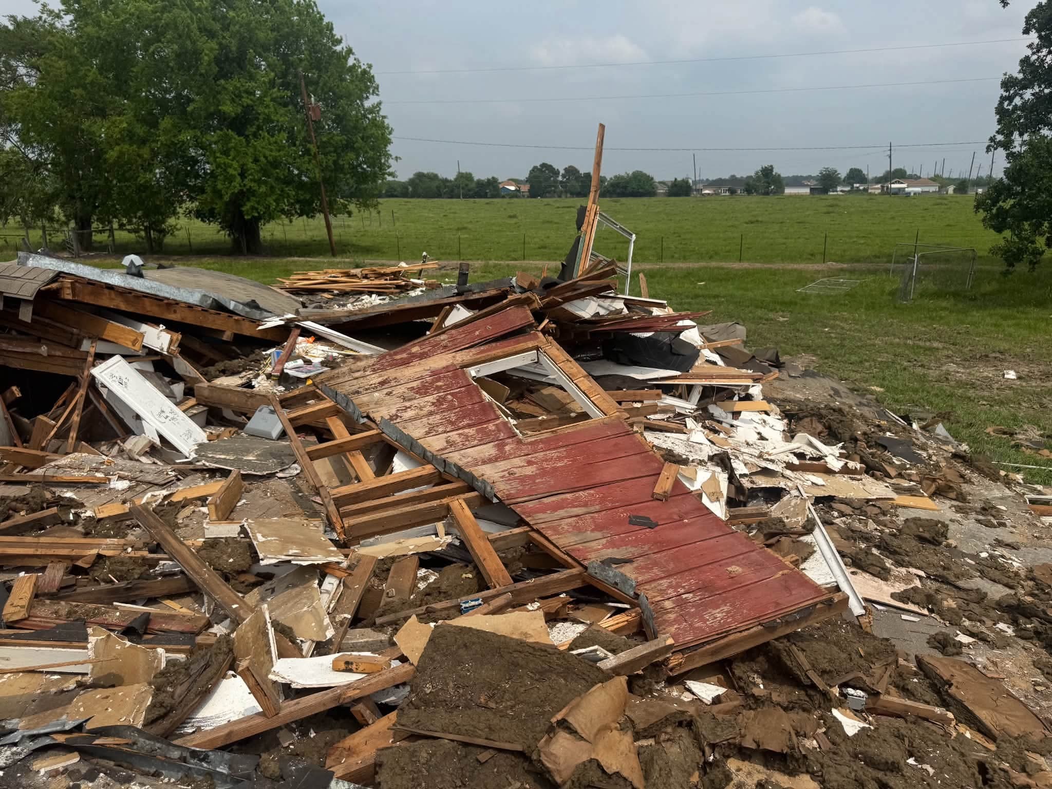 Full property cleanout — debris pile removed from rural Texas land